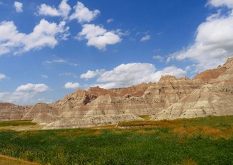 Fototapeta na wymiar Breathtaking view of the Badlands National Park in South Dakota, USA, with gorgeous clouds in the skies.