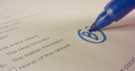 Macro shot of teacher marking a score on a school test