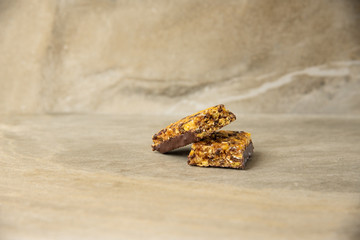 Muesli and cereal bar on marble stone background