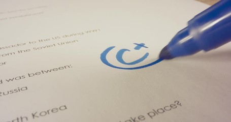 Macro shot of teacher marking a score on a school test