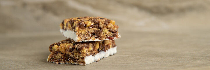 Muesli and cereal bar on marble stone background