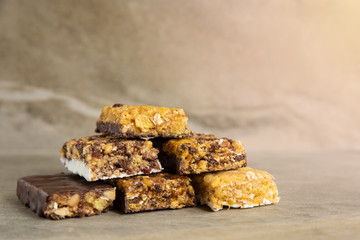 Various muesli bars on marble stone background