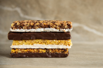 Various muesli bars on marble stone background
