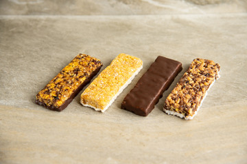 Various muesli bars on marble stone background