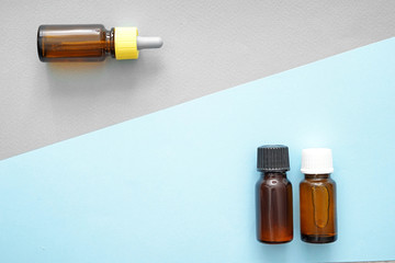 Bottles of oil on color background