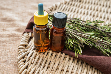 Bottles of fresh rosemary on wicker mat