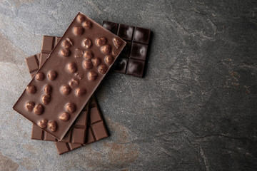 Tasty milk chocolate on grunge background