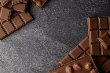 Tasty milk chocolate on grey table