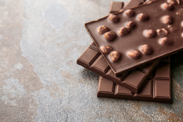 Tasty milk chocolate on grunge background