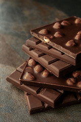 Tasty milk chocolate on grey table