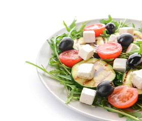 Plate with healthy salad on white background