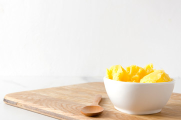 Fresh homemade ghee or clarified butter in white bowl,copy space.Healthy eating and using good...