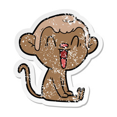 distressed sticker of a cartoon laughing monkey