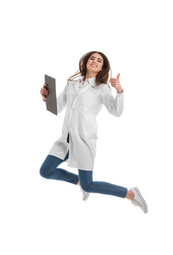 Happy Female Doctor Jumping Against White Background