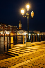 Fototapeta na wymiar Venice canal with historical buildings and gondolas at night. Italy.