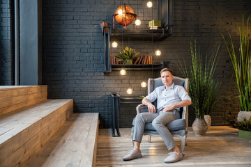 young man sitting on a bench in the park