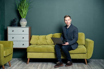 young man sitting on sofa and watching tv
