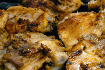 BBQ, grill, kebab. Skinless chicken with fried onions on a grill. Close-up.
