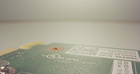 Extreme macro dolly shot of a PCB computer board with capacitors and transistors