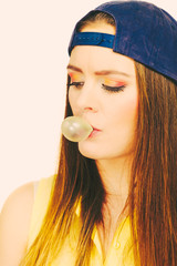 Funky girl making balloon.