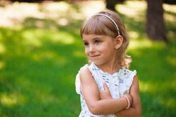 Beautiful little young girl outdoorin a park.