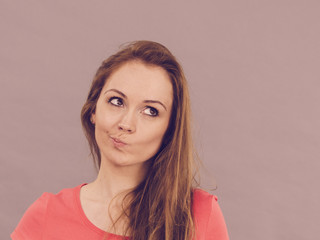 Doubtful woman having displeased expression