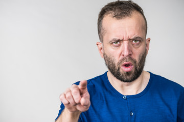 Serious adult man pointing at camera