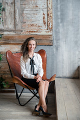 woman sitting on bench in front of brick wall