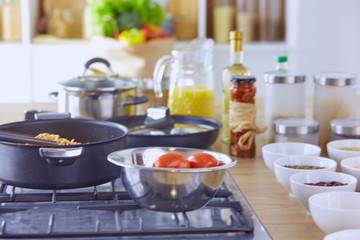 Pasta rolled on fork over pan on stove in the kitchen