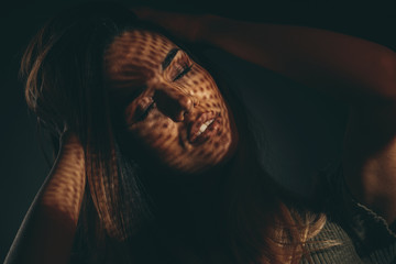 Portrait of a young woman in the studio on dark background