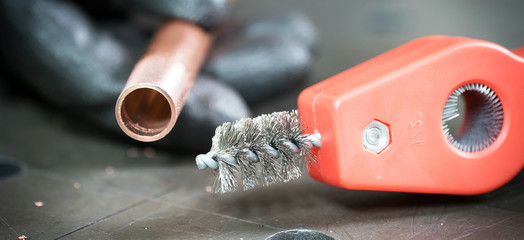  Work in the workshop cleaning and cutting the copper water pipe