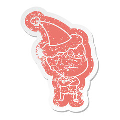 cartoon distressed sticker of an annoyed man wearing santa hat