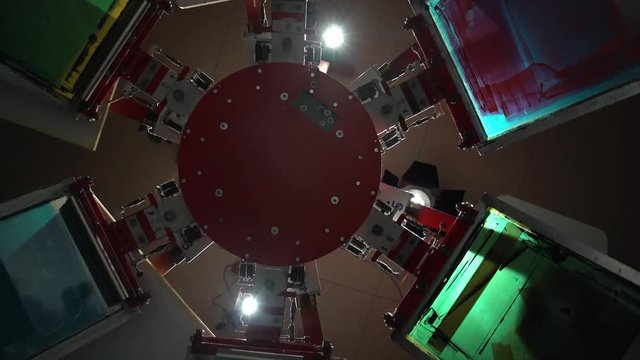 The process of silk screen printing on carousel in dark room