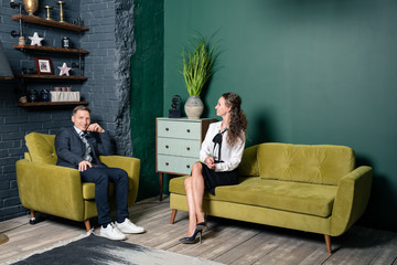 couple sitting on sofa and watching tv