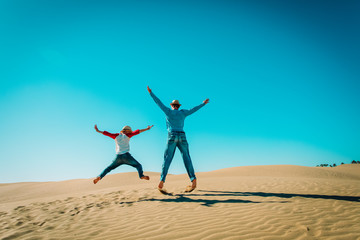 happy father and son having fun in sand dunes