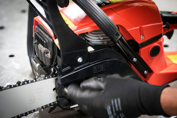 Work in the workshop, changing the chain in the chainsaw