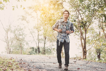Hiking man traveling with backpack in mountains