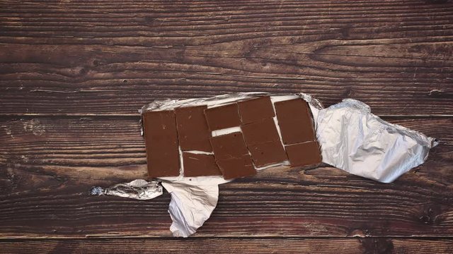 Unwrap Chocalte bar breaking into pieces and eating chocolate - Stop motion animation video