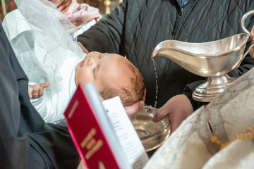 Baptism ceremony in Church. pour holy water on the head. Baptizing a Infant