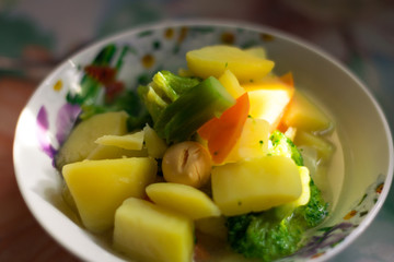 A dish of potatoes, egg yolk, carrots and broccoli. A plate with healthy food