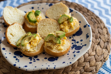 small sandwiches with avocado and scrambled eggs