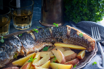 Grilled whole mullet on a wooden table, horizontal