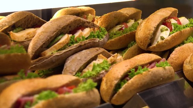 Closeup on sub sandwiches on display on a counter in a store