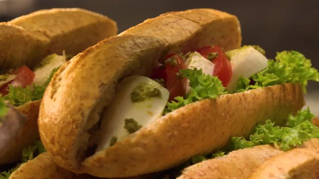 Closeup on sub sandwiches on display on a counter in a store