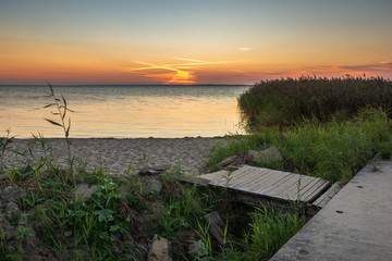 Fototapeta na wymiar Sunset over the Vistula lagoon in Frombork, Warminsko-Mazurskie, Poland