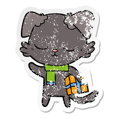 distressed sticker of a cute cartoon dog with christmas present