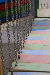 Wooden empty bridge with chains in the children's playground