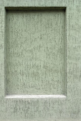 Plastered wall with a closed rectangle window frame, beautiful textured pistachio background for text or image; modern building facade; surface pistachio-colored light gray color with small grain