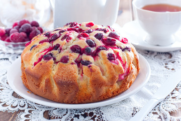 Homemade pie with cranberries and apples on a white napkin, horizontal