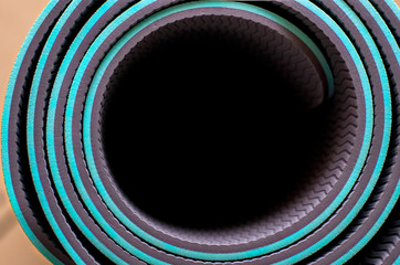 Fototapeta premium Lightweight foam Camping Bed roll. Close up rolled blue color yoga mat texture background,top view, copy space, healthy lifestyle, sport and exercise concept.